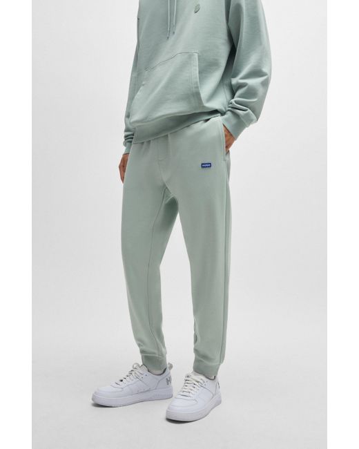HUGO Green Cotton-terry Tracksuit Bottoms With Blue Logo Patch for men