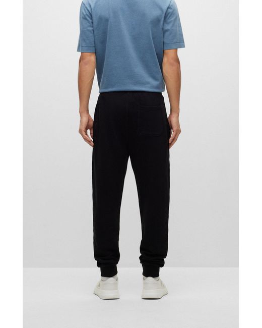 Cotton-terry tracksuit bottoms with fleece logo
