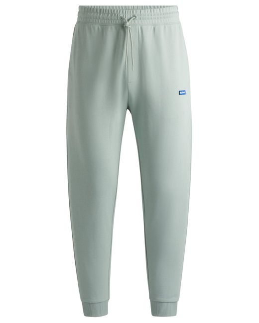 HUGO Green Cotton-terry Tracksuit Bottoms With Blue Logo Patch for men