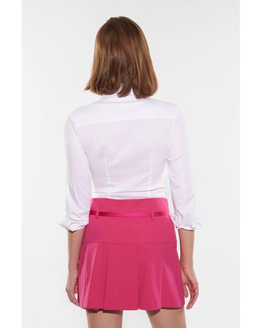 Mini-jupe corolle unie avec ceinture fine Imperial en coloris Pink