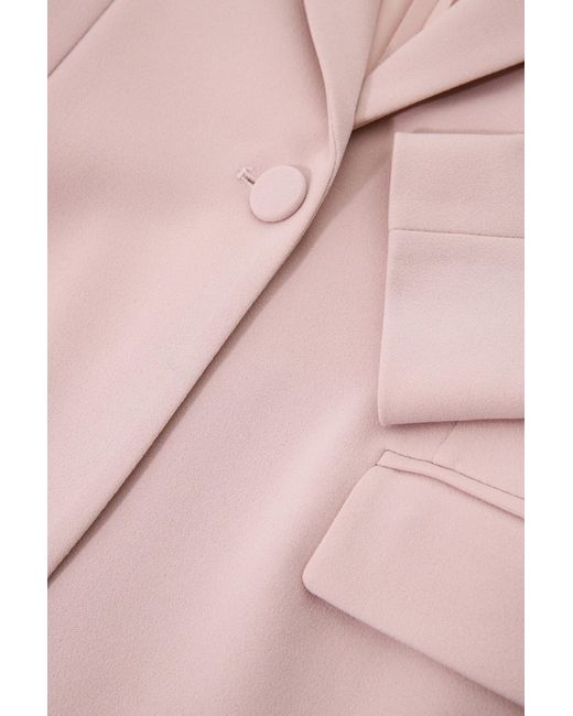 Veste à boutonnage simple, revers classiques et des poches passepoilées Imperial en coloris Pink