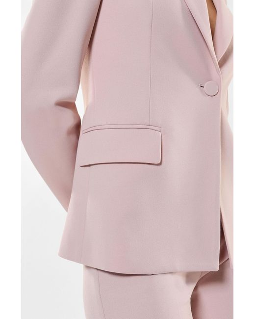 Veste à boutonnage simple, revers classiques et des poches passepoilées Imperial en coloris Pink