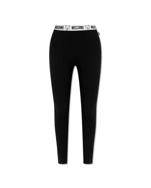 https://cdna.lystit.com/520/650/n/photos/italist/272fd92d/moschino-Black-Flocked-Logo-waistband-Slim-cut-Leggings.jpeg