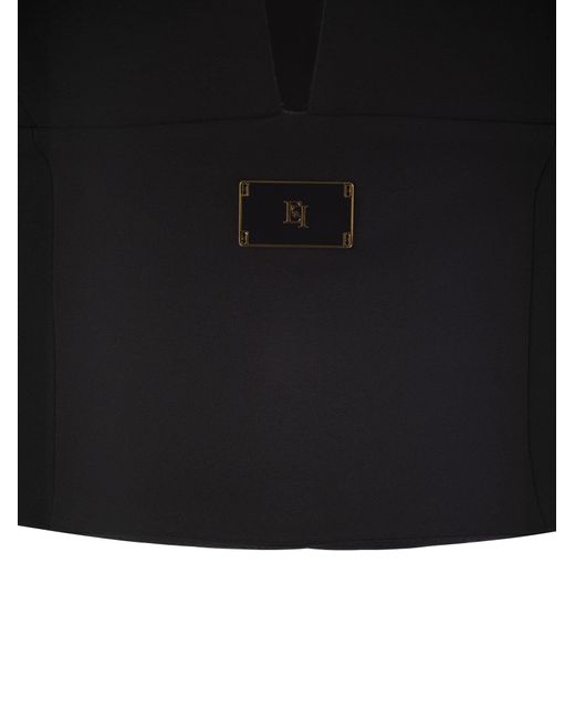 Black crepe bustier women's top with enamelled logo plaque