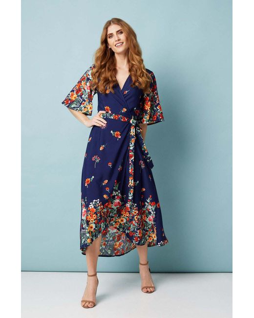 Izabel London Floral Border Print Wrap Dress in Navy (Blue) Lyst UK