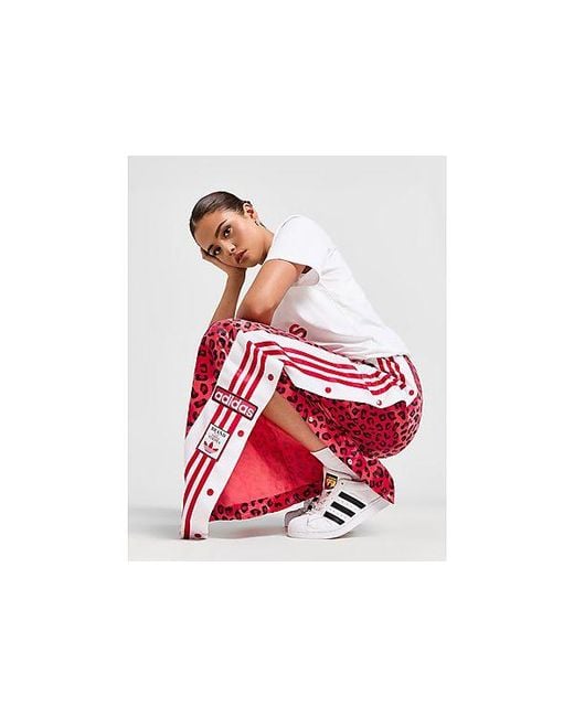 Pantalon de jogging jambes larges Leopard Luxe Adibreak Adidas Originals en coloris Red