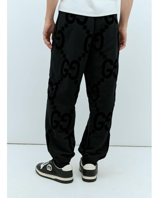 Gucci Black Gg Flocked Print Cotton-fleece Track Pants for men