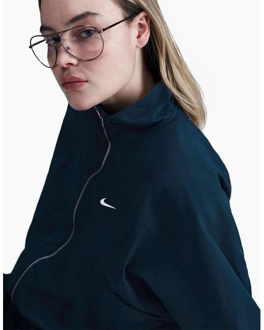 Nike Blue Solid Patterned Zipped Pocket Windbreaker Jacket