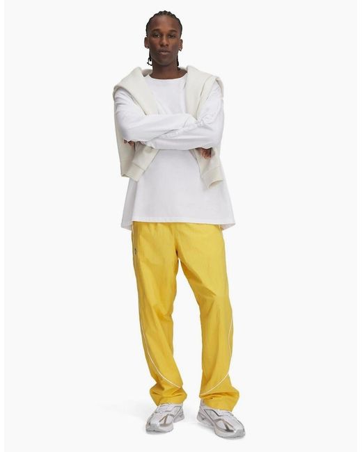 Under Armour Yellow Solid Patterned Track Pants for men