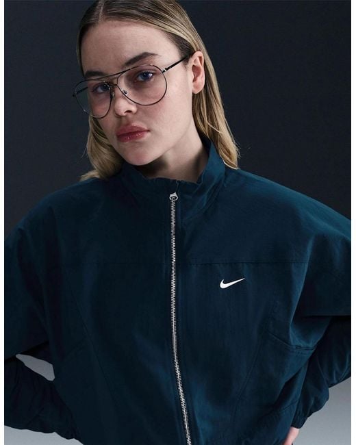 Nike Blue Solid Patterned Zipped Pocket Windbreaker Jacket