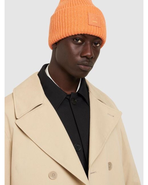 Cappello beanie pansie face in lana di Acne in Orange da Uomo