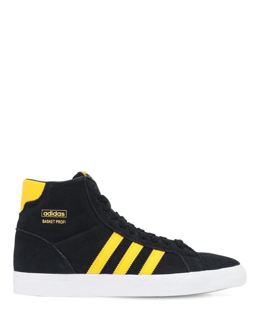 black and yellow adidas high tops