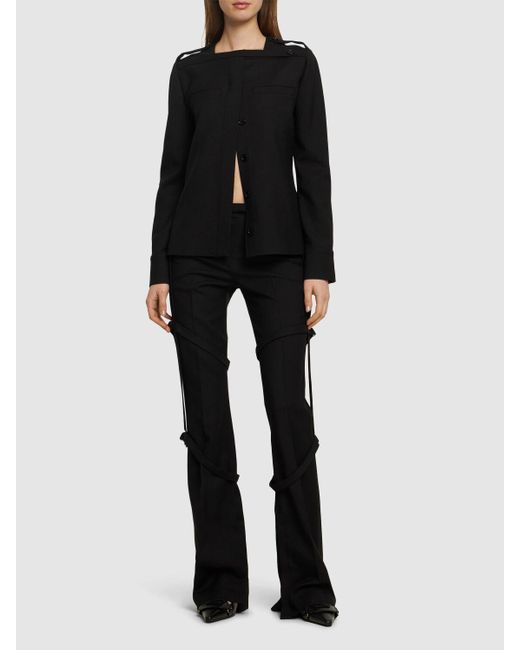 Multi-strap bootcut wool pants di Courreges in Black