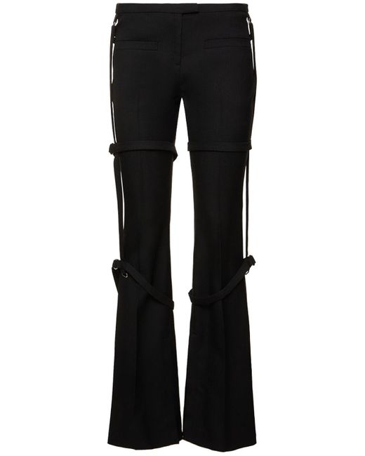 Multi-strap bootcut wool pants di Courreges in Black