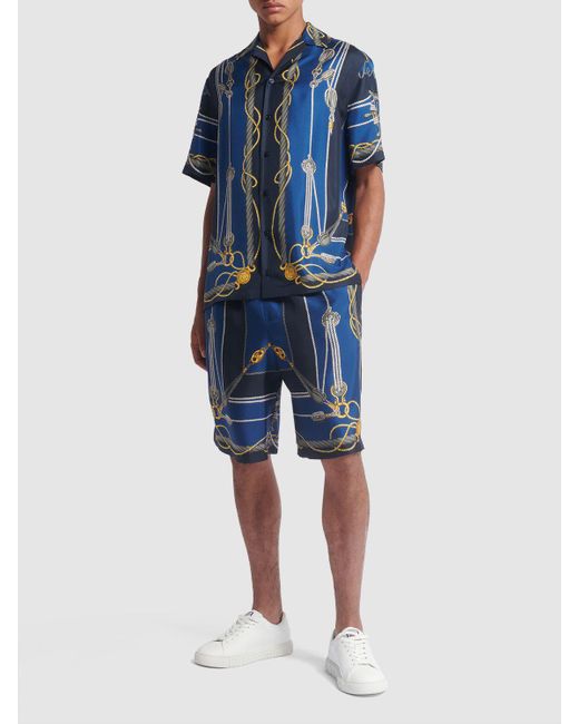 Shorts in seta stampata di Versace in Blue da Uomo