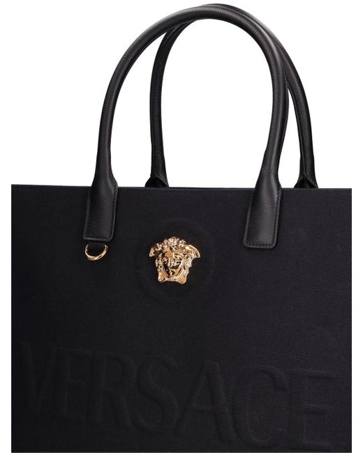 Tote bag en toile à logo Versace en coloris Black