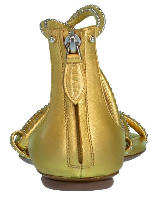 alaia gold sandals