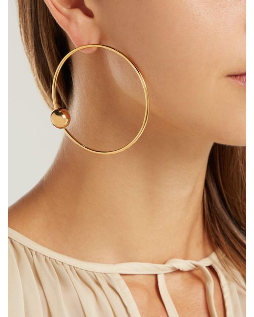 Lyst Jil Sander Asymmetric Sphere Hoop Earrings in Metallic