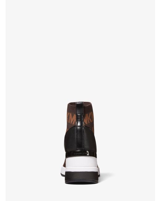 Zapatilla Skyler tipo calcetín de punto elástico con logotipo Michael Kors  de Cuero de color Marrón | Lyst