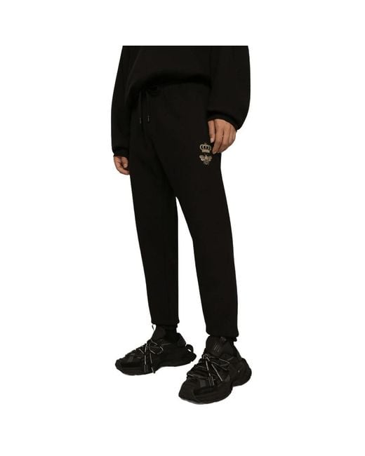 Pantaloni in cotone nero con logo dorato di Dolce & Gabbana in Black da Uomo