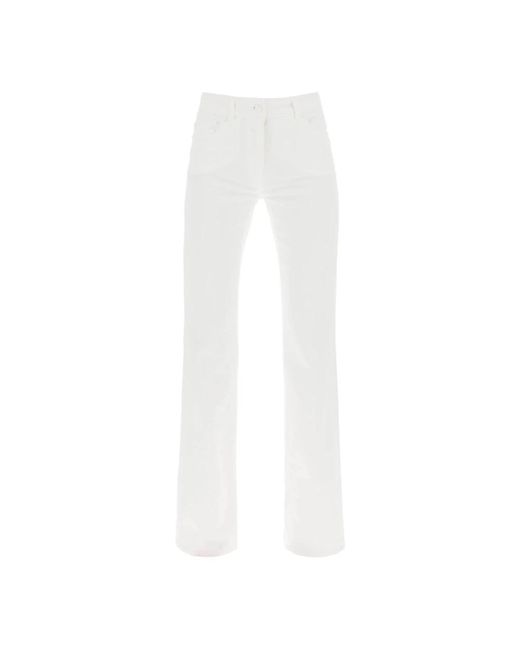 Jeans a zampa in denim di cotone di Moschino in White