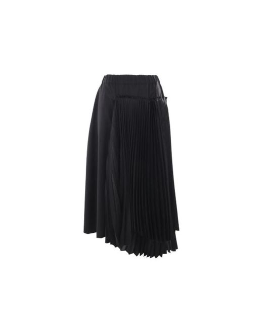 Falda midi plisada de lana negra Noir Kei Ninomiya de color Black