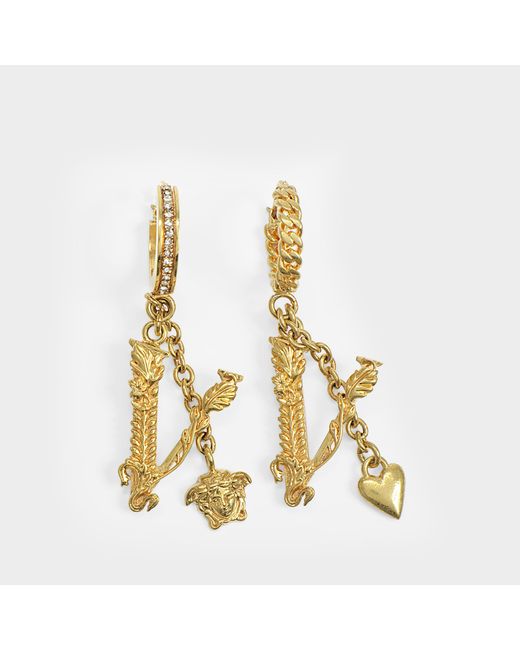 Versace Metallic V Drop Earrings In Golden Brass And Strass