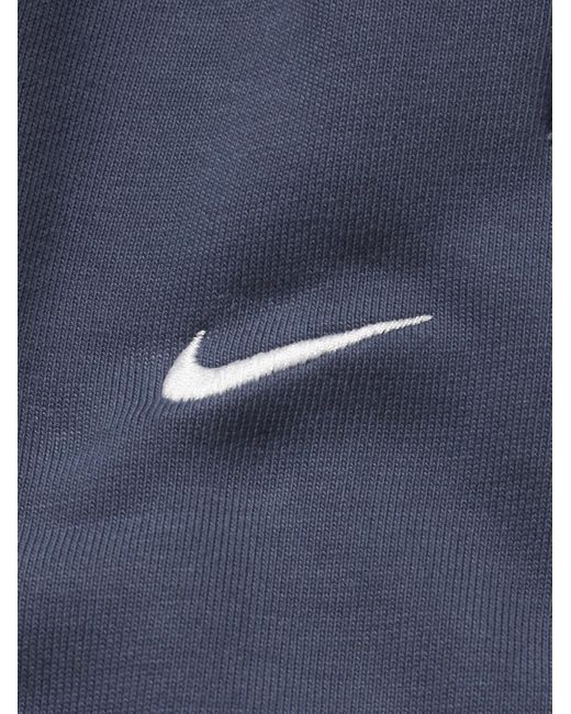 Pantaloni sportivi a gamba affusolata in jersey di misto cotone con logo ricamato Solo Swoosh di Nike in Blue da Uomo