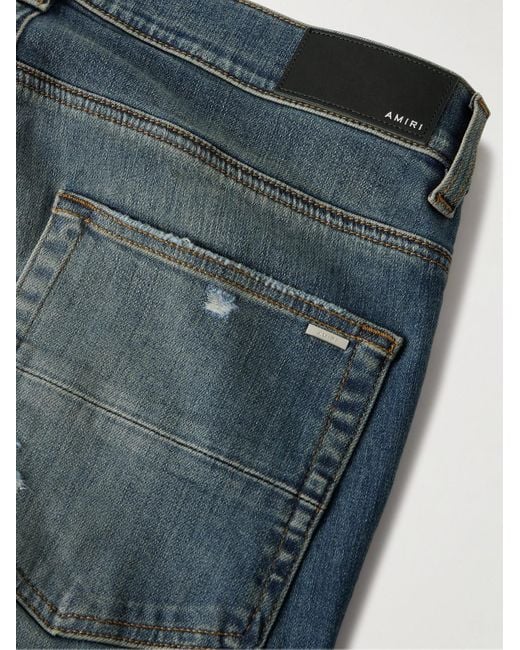 Jeans skinny effetto consumato con inserti MX1 di Amiri in Blue da Uomo
