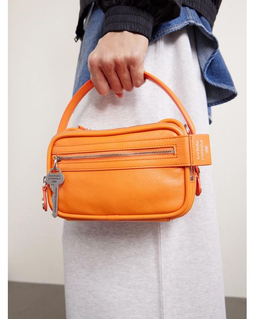 Camero Embellished Textured-Leather Messenger Bag di Acne in Orange da Uomo