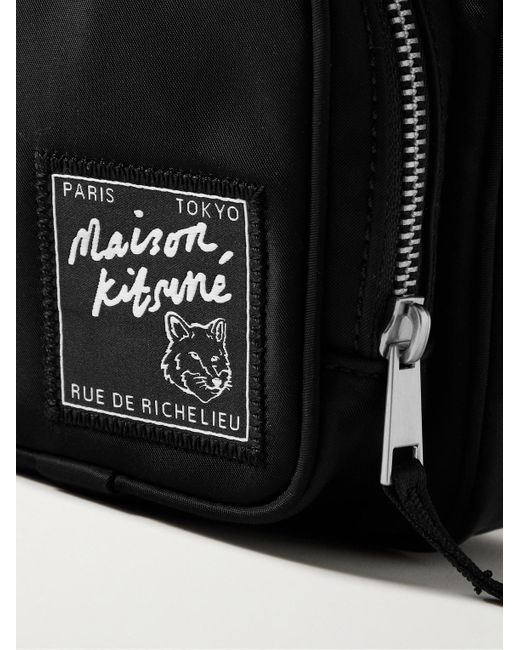 Pochette in nylon con logo applicato The Traveller di Maison Kitsuné in Black da Uomo