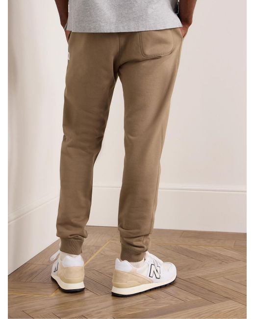 Pantaloni sportivi a gamba affusolata in jersey di cotone con logo applicato di Reigning Champ in Natural da Uomo