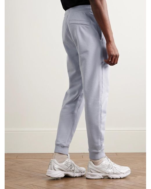 Stone Island Blue Tapered Logo-Appliquéd Garment-Dyed Cotton-Jersey Sweatpants for men