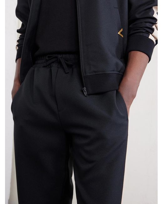 Valentino Garavani Blue Tapered Logo-appliqued Striped Drill Sweatpants for men