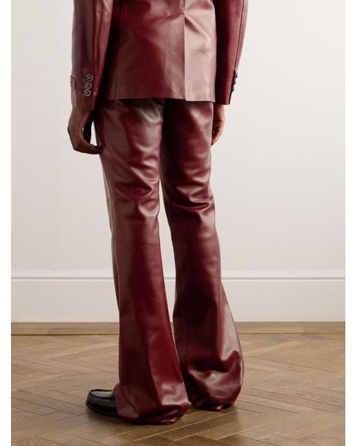 Pantaloni svasati slim-fit in pelle di Versace in Red da Uomo