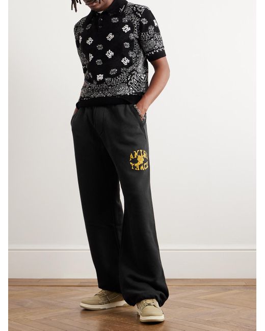 Amiri Black Wide-leg Logo-flocked Cotton-jersey Sweatpants for men