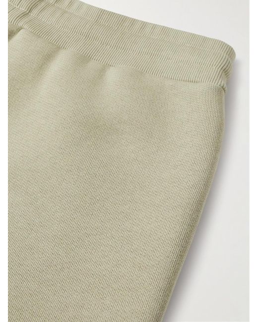 Pantaloni sportivi a gamba affusolata in misto cotone con logo goffrato di AMI in Natural da Uomo