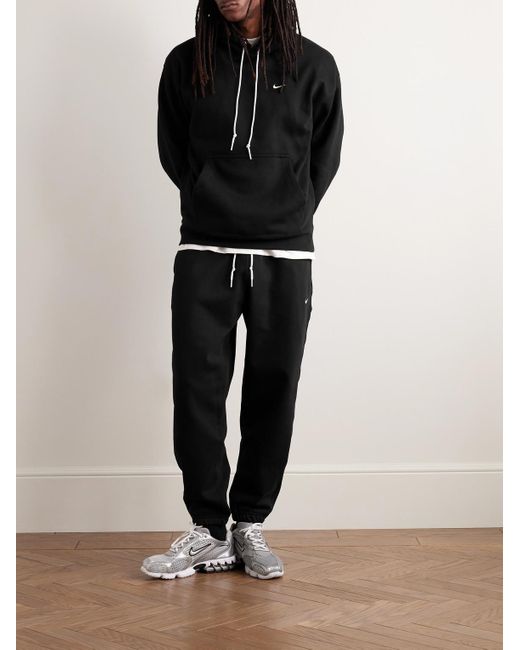 Nike Solo Swoosh schmal zulaufende Jogginghose aus Jersey aus einer Baumwollmischung mit Logostickerei in Black für Herren