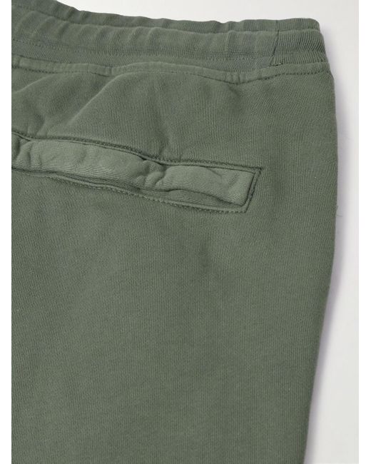 Pantaloni sportivi a gamba affusolata in jersey di cotone tinti in capo con logo applicato di Stone Island in Green da Uomo