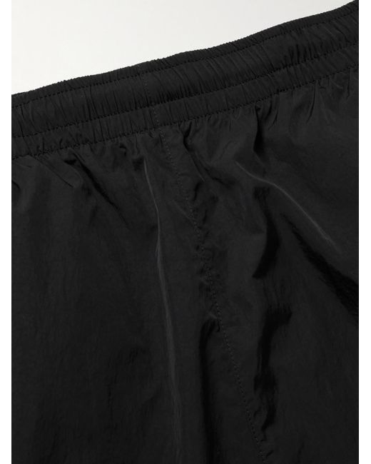 Pantaloni sportivi a gamba affusolata in taffetà con logo ricamato Solo Swoosh di Nike in Black da Uomo