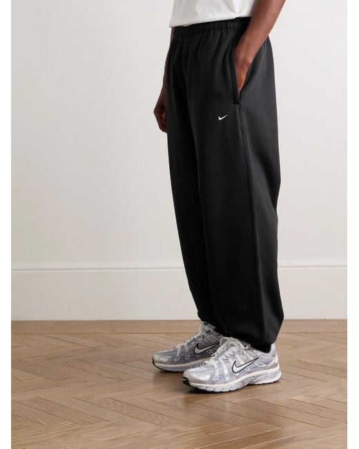 Nike Solo Swoosh schmal zulaufende Jogginghose aus Jersey aus einer Baumwollmischung mit Logostickerei in Black für Herren