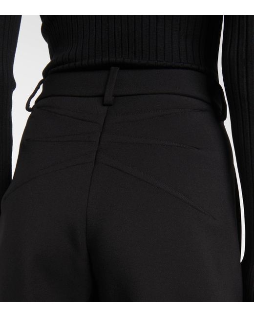 Pantalon ample en laine a taille haute Alaïa en coloris Black