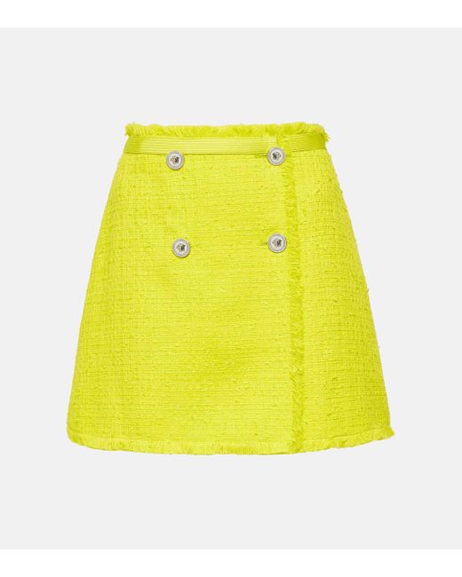 Mini-jupe en tweed de coton melange Versace en coloris Yellow