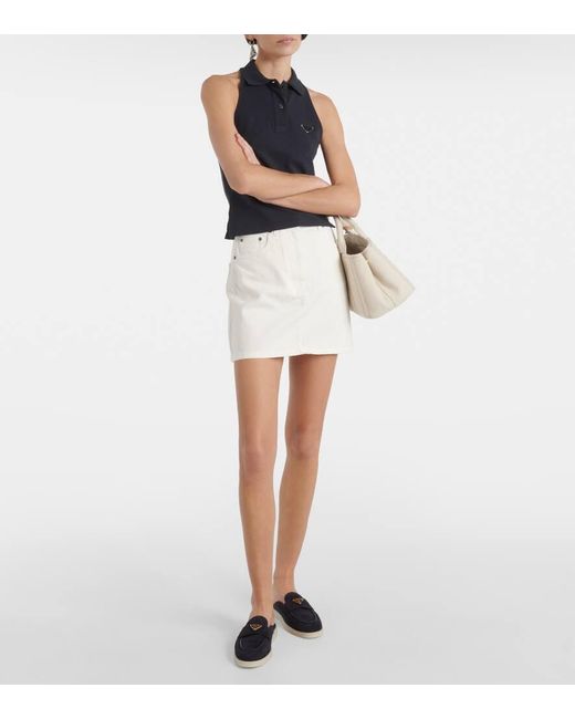 Minifalda de denim de tiro alto Prada de color White