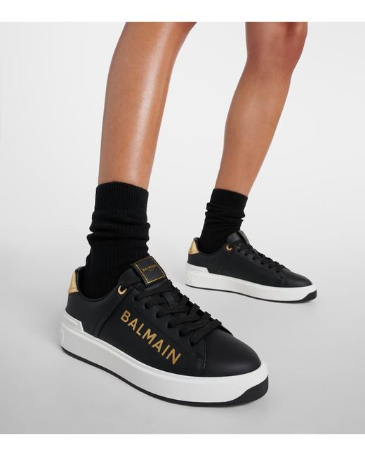 Sneakers in pelle di vitello nero/oro di Balmain in Black
