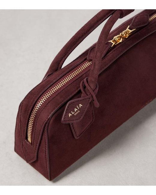 Clutch Le Teckel di Alaïa in Purple