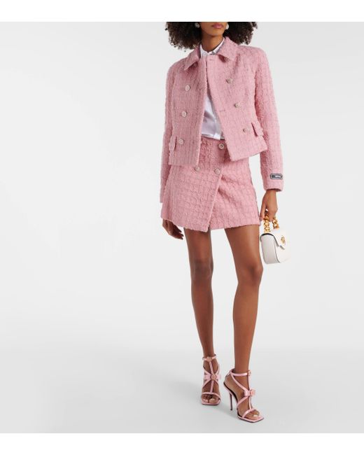 Mini-jupe en tweed de laine melangee Versace en coloris Pink