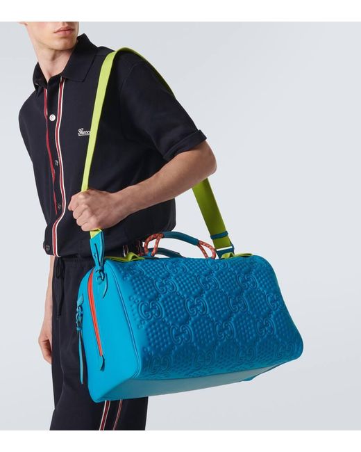 Gucci Blue Embossed GG Leather-trimmed Duffel Bag for men