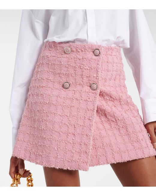 Mini-jupe en tweed de laine melangee Versace en coloris Pink