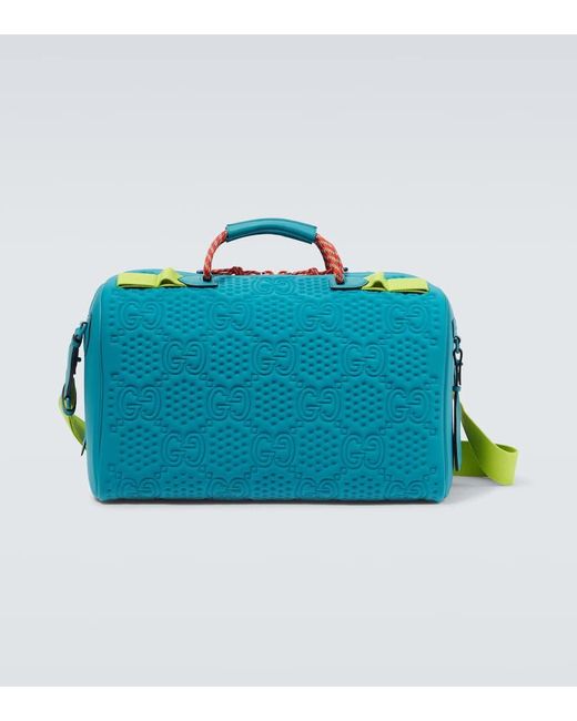 Gucci Blue Embossed GG Leather-trimmed Duffel Bag for men